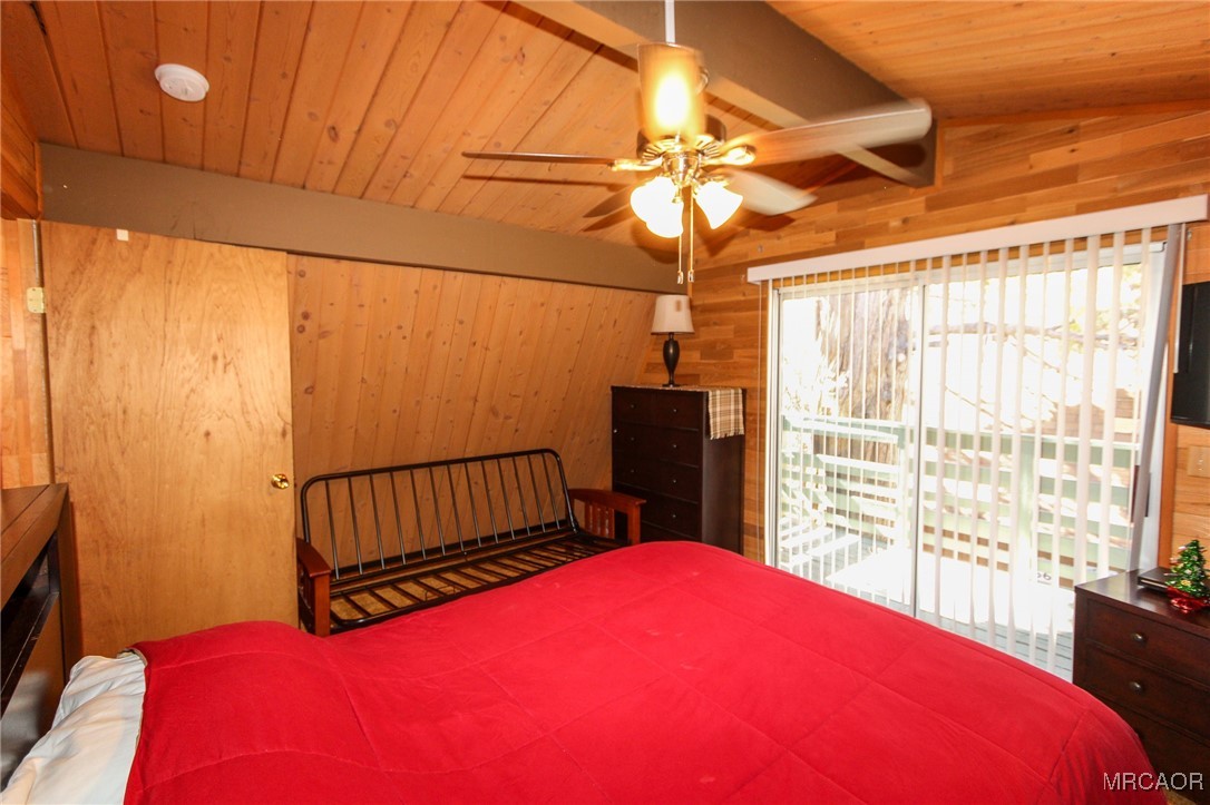 692 San Bernardino Avenue Sugarloaf, CA 92386 - Photo 14 of 20 a bedroom with a bed and a window