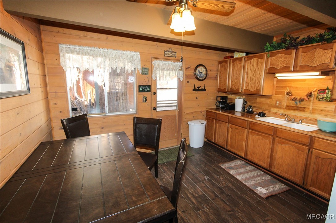 692 San Bernardino Avenue Sugarloaf, CA 92386 - Photo 7 of 20 a open kitchen with stainless steel appliances granite countertop a sink dishwasher a stove a refrigerator with wooden cabinets and wooden floor