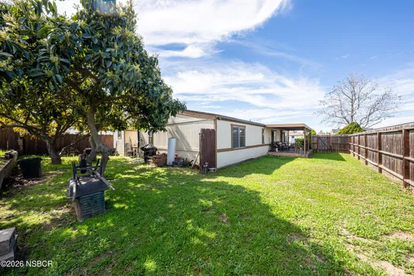 a kitchen with stainless steel appliances granite countertop a stove a sink dishwasher and cabinets with wooden floor