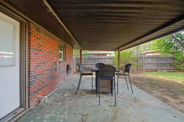 a view of a backyard with a patio and a patio