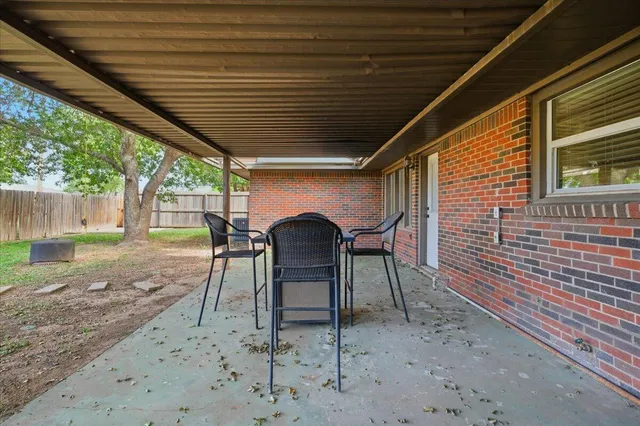 a view of a chairs and table in the patio