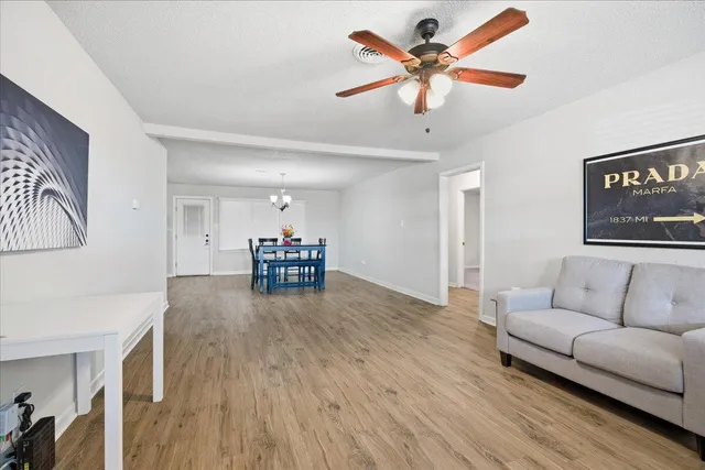 a living room with furniture and a ceiling fan