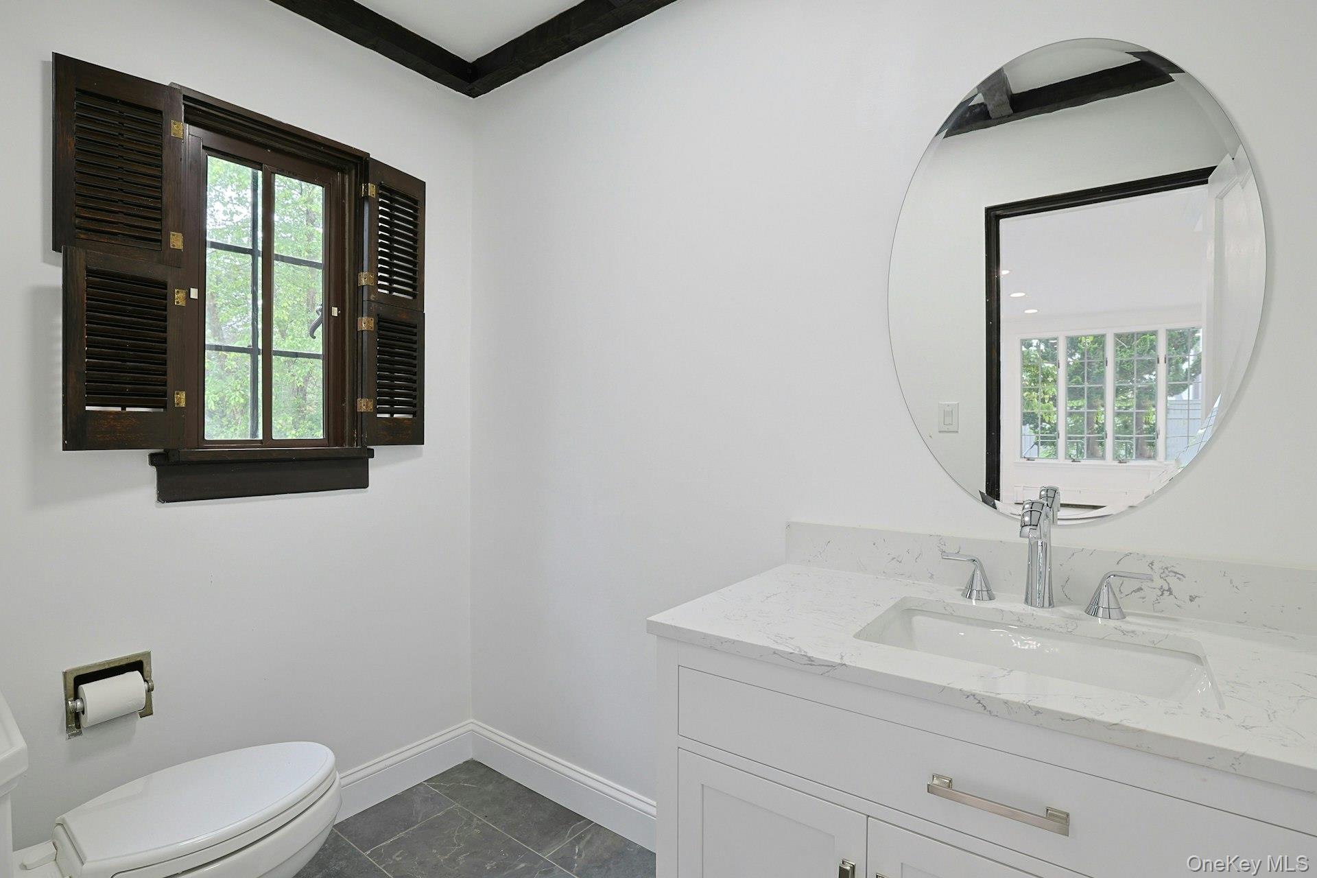 14 Withington Road Scarsdale, NY 10583 - Photo 18 of 41 a bathroom with a toilet sink vanity and mirror