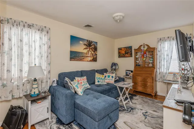 a living room with furniture a couch and a flat screen tv
