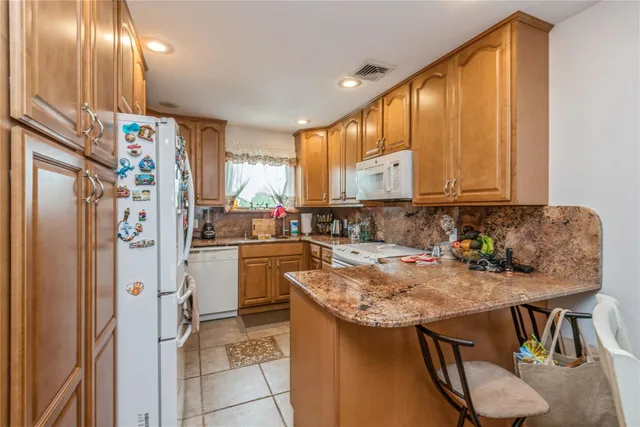 a kitchen with refrigerator and cabinets
