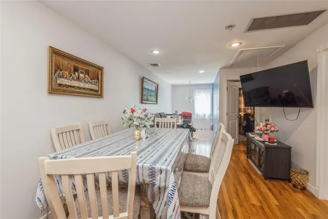 a view of a dining room with furniture and a flat screen tv