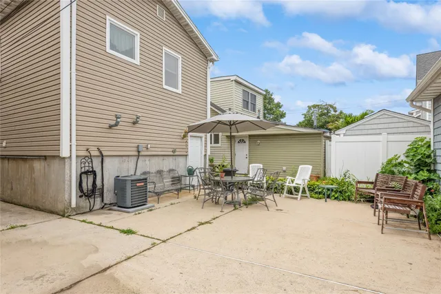 a couple of table and chairs in front of house