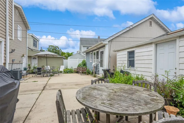 a view of a patio with table and chairs and potted plants