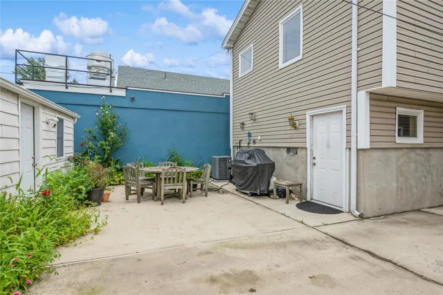 a view of a patio with table and chairs and potted plants