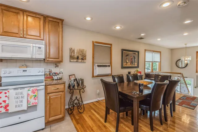 a view of a dining room with furniture and a window