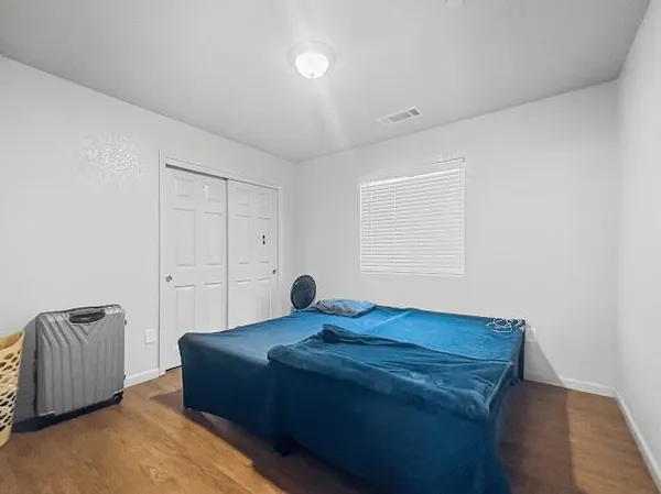 a bedroom with bed and a window