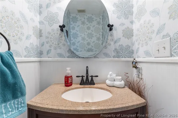 a bathroom with a sink and mirror