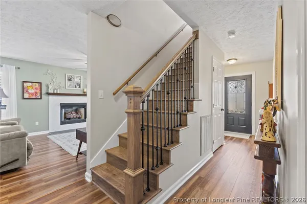 a view of entryway and hall with wooden floor