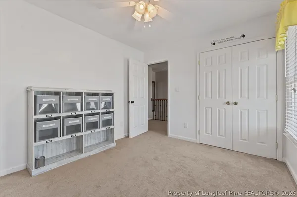 an empty room with furniture and a chandelier
