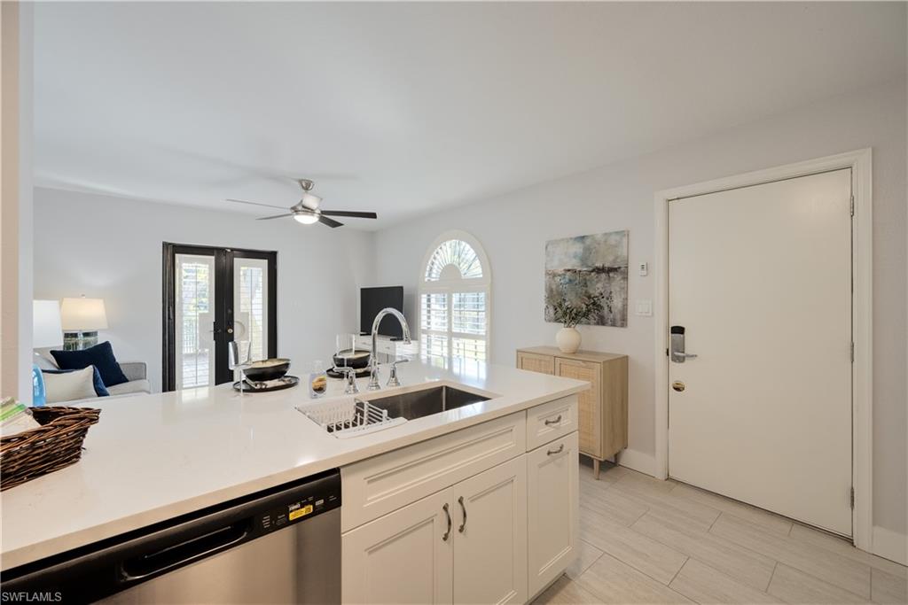 655 8th Avenue South, Unit 3 Naples, FL 34102 - Photo 27 of 48 a view of a sink and a refrigerator a mirror