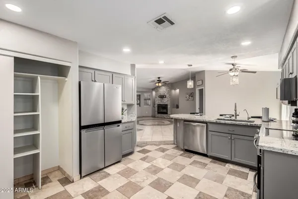a kitchen with stainless steel appliances a refrigerator sink and microwave