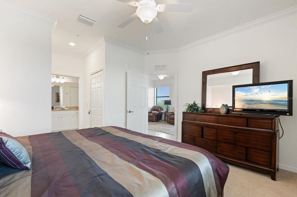 16904 Vardon Terrace, Unit 301 Lakewood Ranch, FL 34211 - Photo 17 of 28 a bedroom with a bed and a flat screen tv
