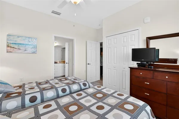 a bedroom with a bed and a chandelier