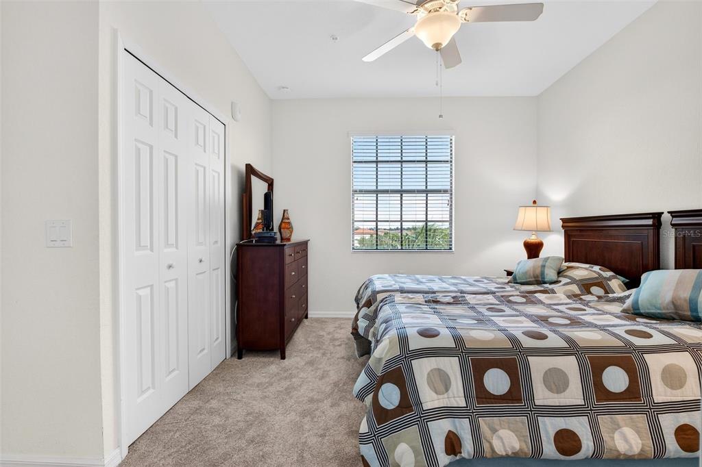16904 Vardon Terrace, Unit 301 Lakewood Ranch, FL 34211 - Photo 21 of 53 a bedroom with a bed and a chandelier