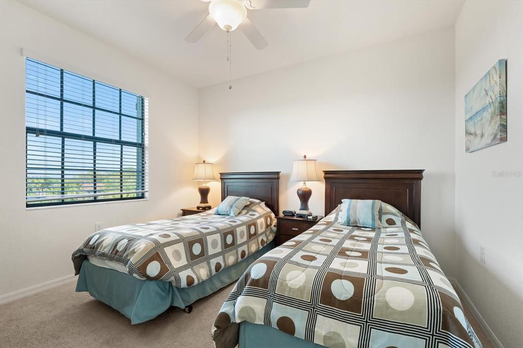 16904 Vardon Terrace, Unit 301 Lakewood Ranch, FL 34211 - Photo 21 of 28 a bedroom with two beds and a window