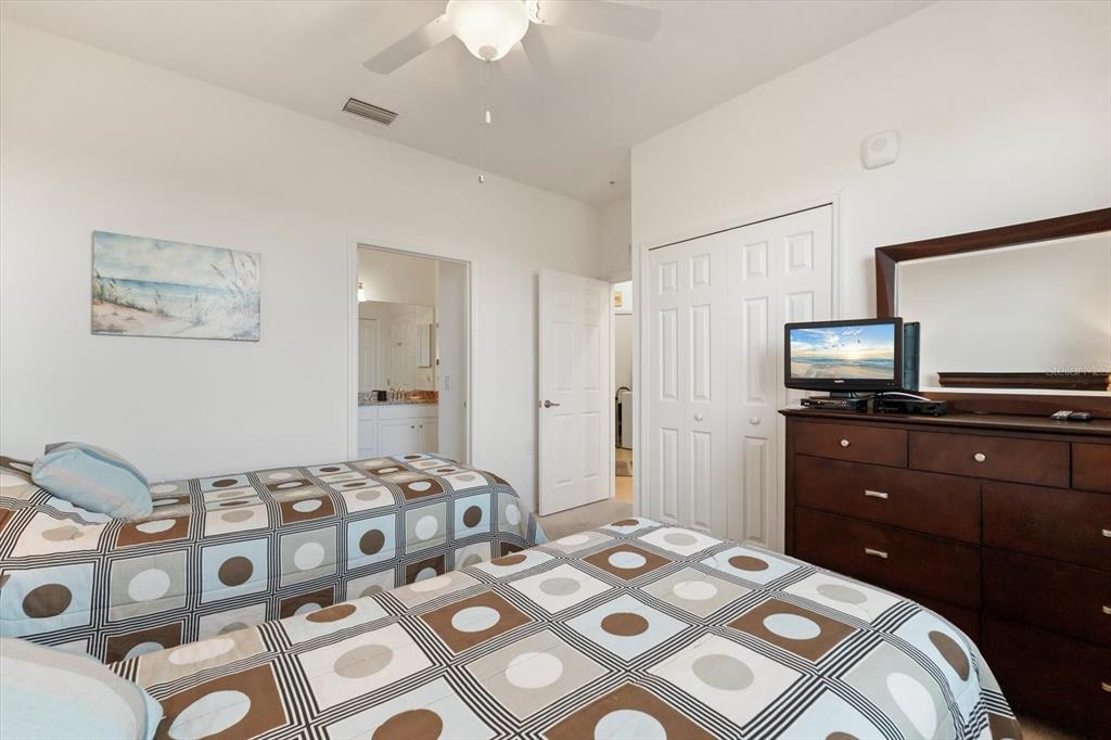 16904 Vardon Terrace, Unit 301 Lakewood Ranch, FL 34211 - Photo 22 of 28 a bedroom with a bed and a flat screen tv