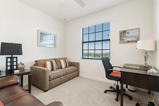 a living room with furniture a lamp and a window