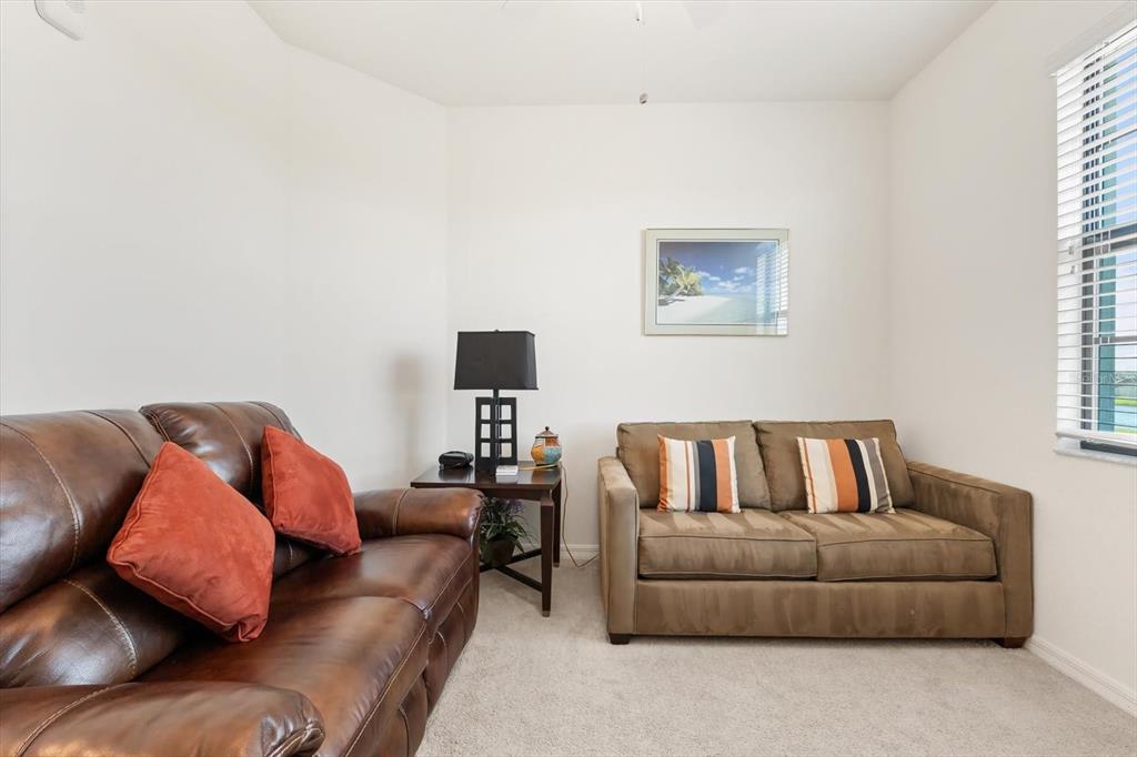 16904 Vardon Terrace, Unit 301 Lakewood Ranch, FL 34211 - Photo 24 of 28 a living room with furniture and a couch