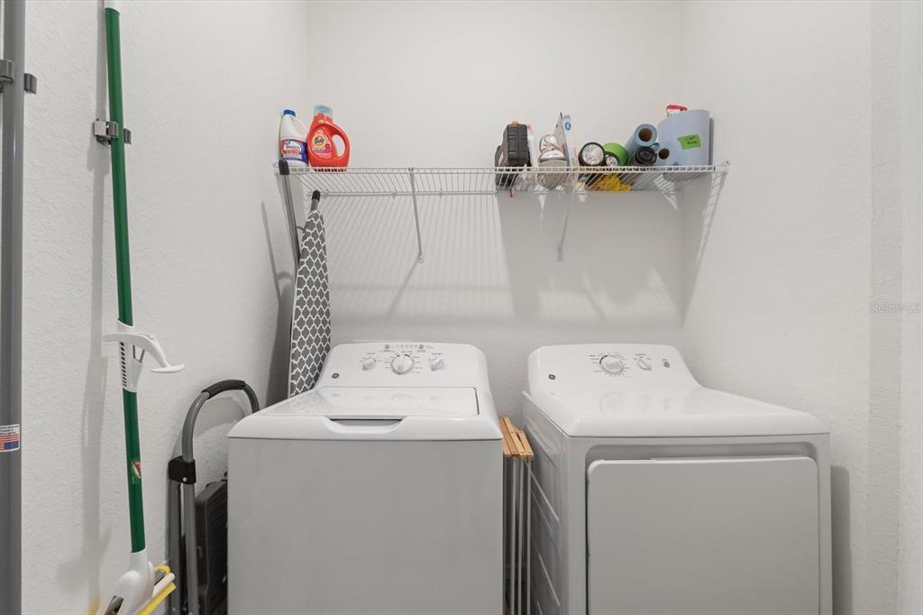16904 Vardon Terrace, Unit 301 Lakewood Ranch, FL 34211 - Photo 25 of 28 a bathroom with a sink and a washer dryer