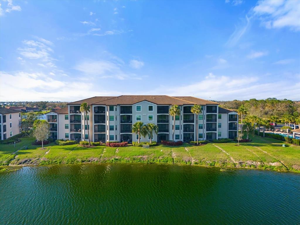 16904 Vardon Terrace, Unit 301 Lakewood Ranch, FL 34211 - Photo 27 of 28 a view of a house with swimming pool and yard