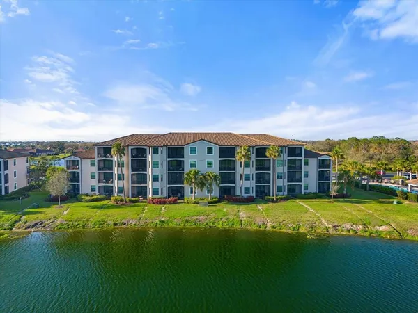 a swimming pool with outdoor seating and lake view