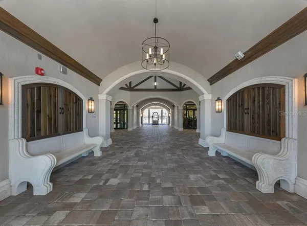 a view of a room with lots of wooden floor and a chandelier