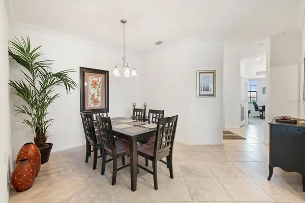 a kitchen with a stove a sink dishwasher a refrigerator and white cabinets with wooden floor