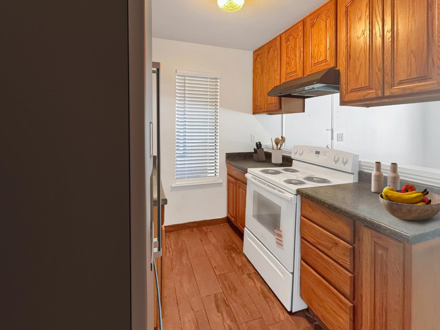 6724 Plymouth Road, Unit 44 Stockton, CA 95207 - Photo 1 of 1 a kitchen with stainless steel appliances a stove a sink a refrigerator and cabinets