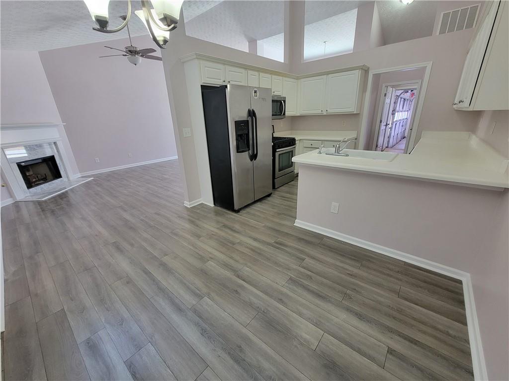 2213 Carlton Chase Road Dacula, GA 30019 - Photo 9 of 30 a view of a refrigerator in kitchen and an empty room