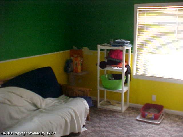 4316 South Jackson Street Amarillo, TX 79110 - Photo 7 of 8 a bedroom with a bed and a window