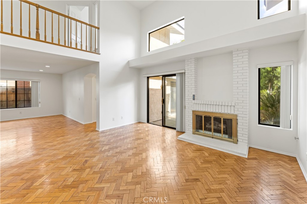 55 Tidewind, Unit 54 Irvine, CA 92603 - Photo 13 of 39 a view of an empty room with a fireplace and a window
