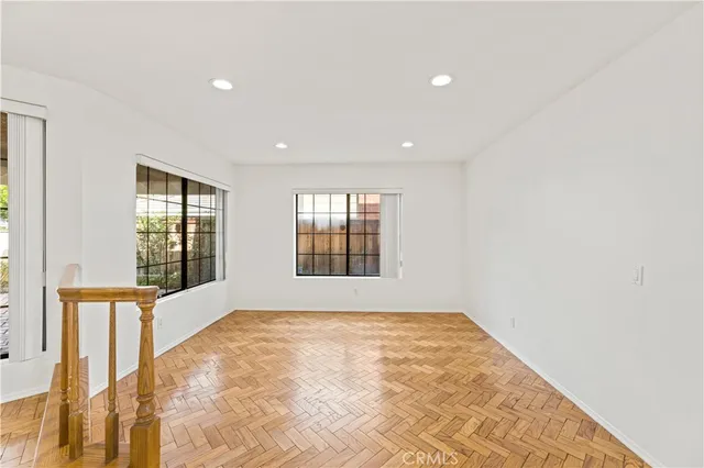 a view of a kitchen with wooden floor and electronic appliances
