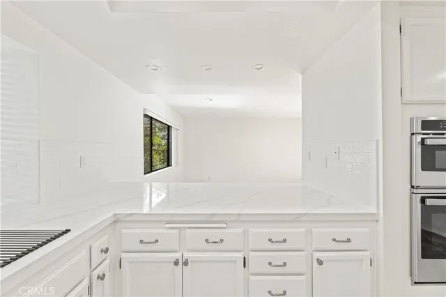 a view of a kitchen with a sink and cabinets