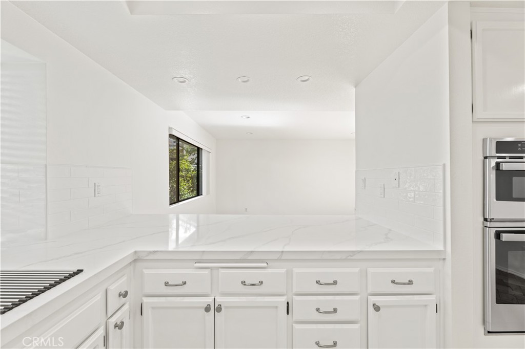 55 Tidewind, Unit 54 Irvine, CA 92603 - Photo 18 of 39 a view of cabinets with wooden floor