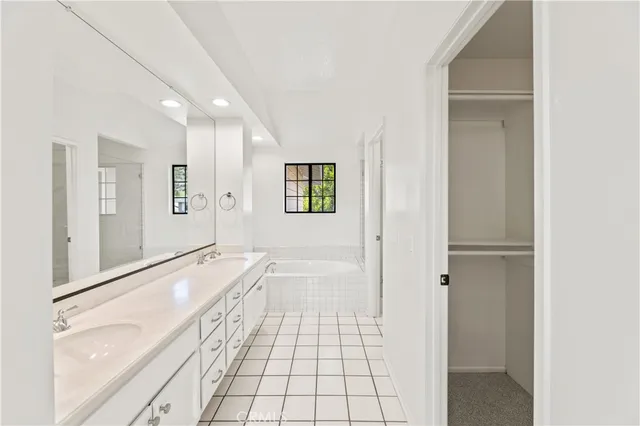 a bathroom with a granite countertop toilet a sink and shower