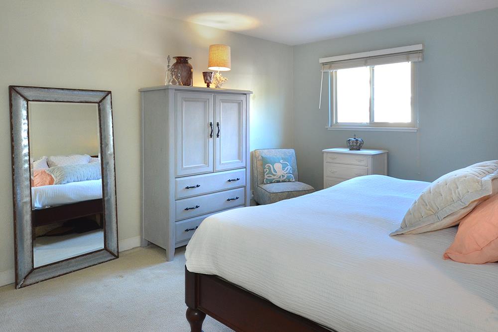 114 Solano Avenue La Selva Beach, CA 95076 - Photo 15 of 38 a bedroom with a bed and a mirror