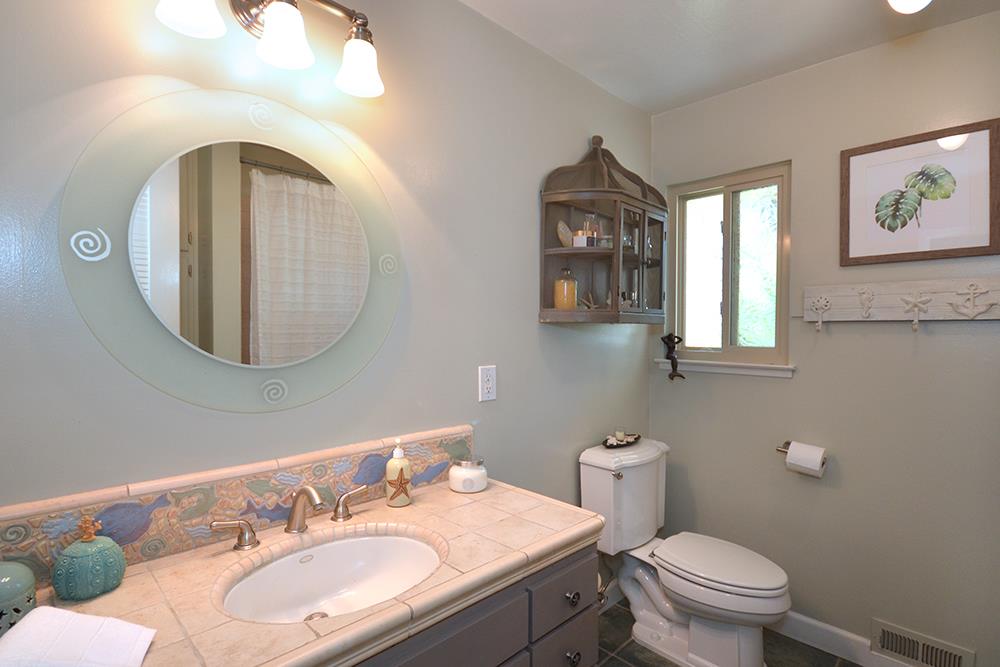 114 Solano Avenue La Selva Beach, CA 95076 - Photo 22 of 38 a bathroom with a toilet a sink and mirror