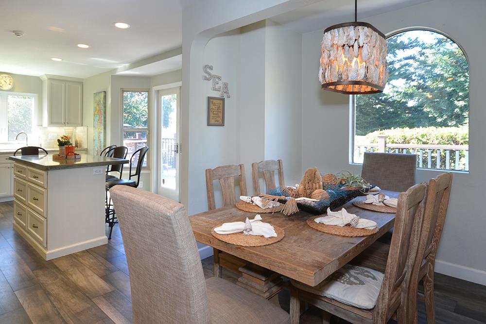 114 Solano Avenue La Selva Beach, CA 95076 - Photo 6 of 38 a view of a dining room with furniture a chandelier and wooden floor