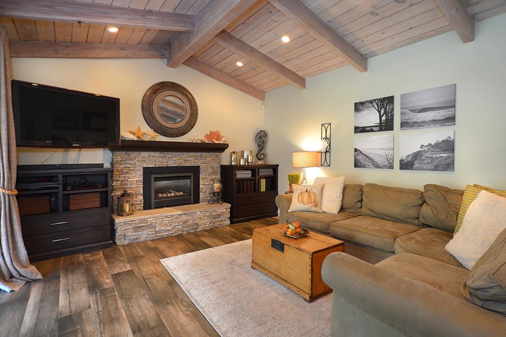 114 Solano Avenue La Selva Beach, CA 95076 - Photo 8 of 38 a living room with furniture a flat screen tv and a fireplace