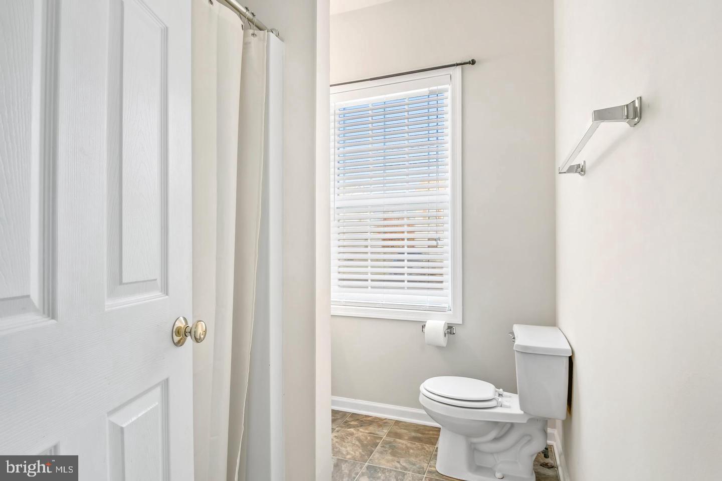 8186 June Way, Unit 601 Easton, MD 21601 - Photo 25 of 30 a white toilet sitting next to a bathroom sink