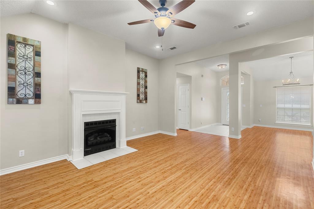 2917 Harlow Road Commerce, TX 75428 - Photo 4 of 40 a view of empty room with wooden floor and fireplace