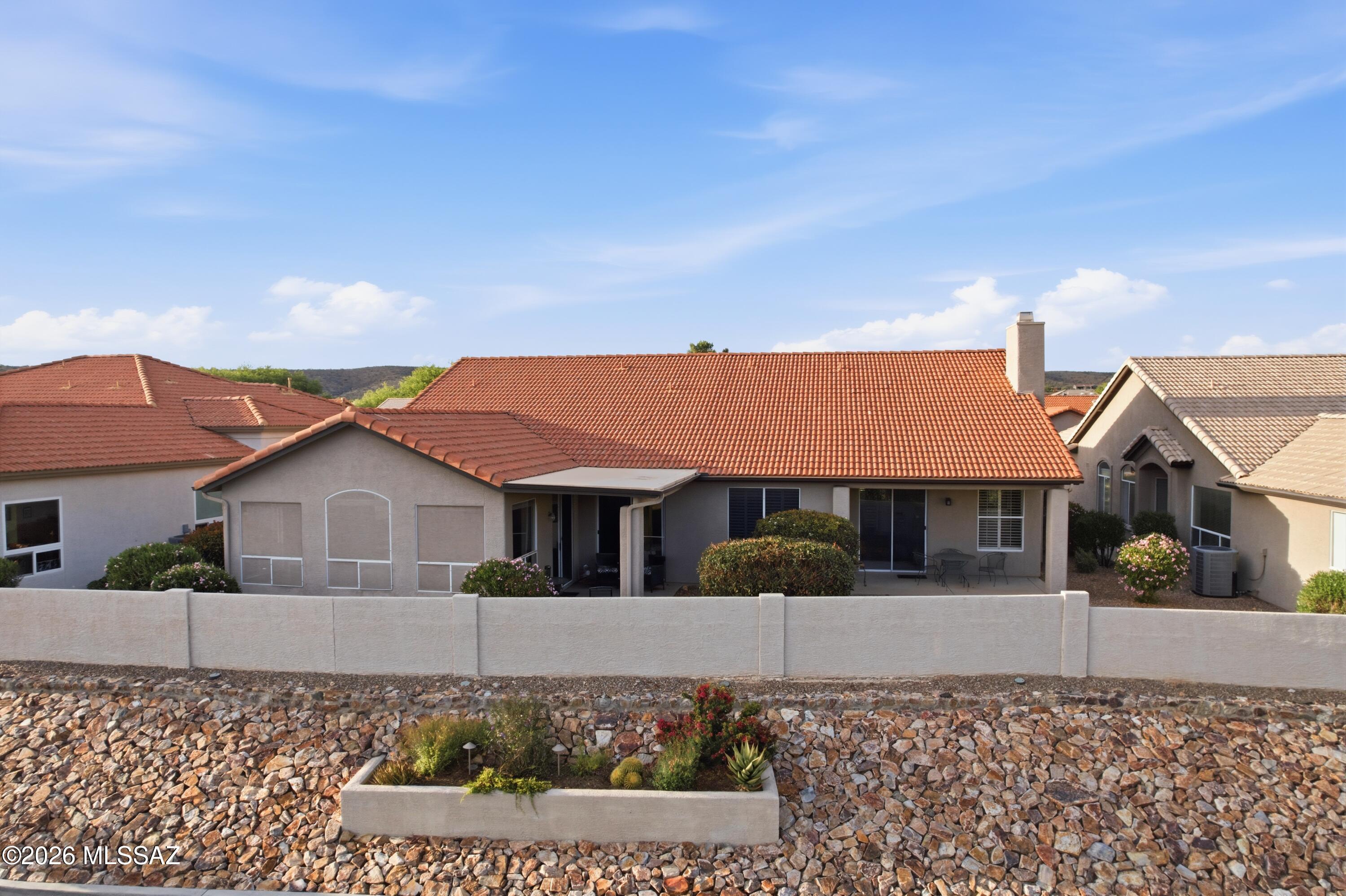 64351 East Wind Ridge Circle Tucson, AZ 85739 - Photo 35 of 41 a front view of a house with a garden