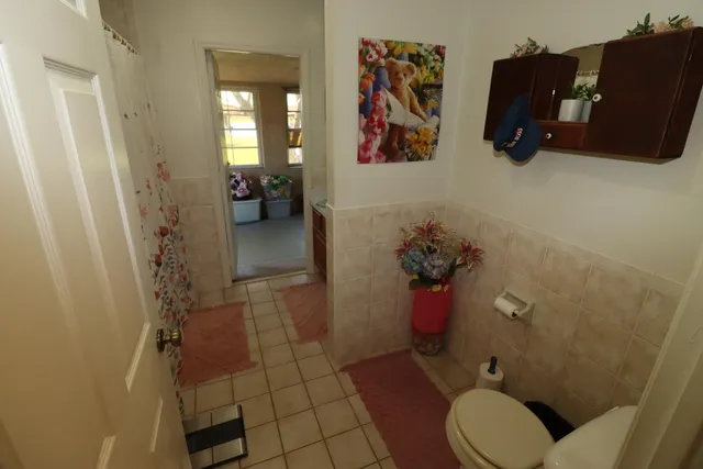 a bathroom with a toilet and a shower curtain