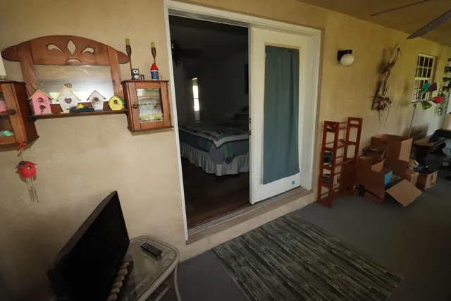 a view of a livingroom with furniture and a hallway