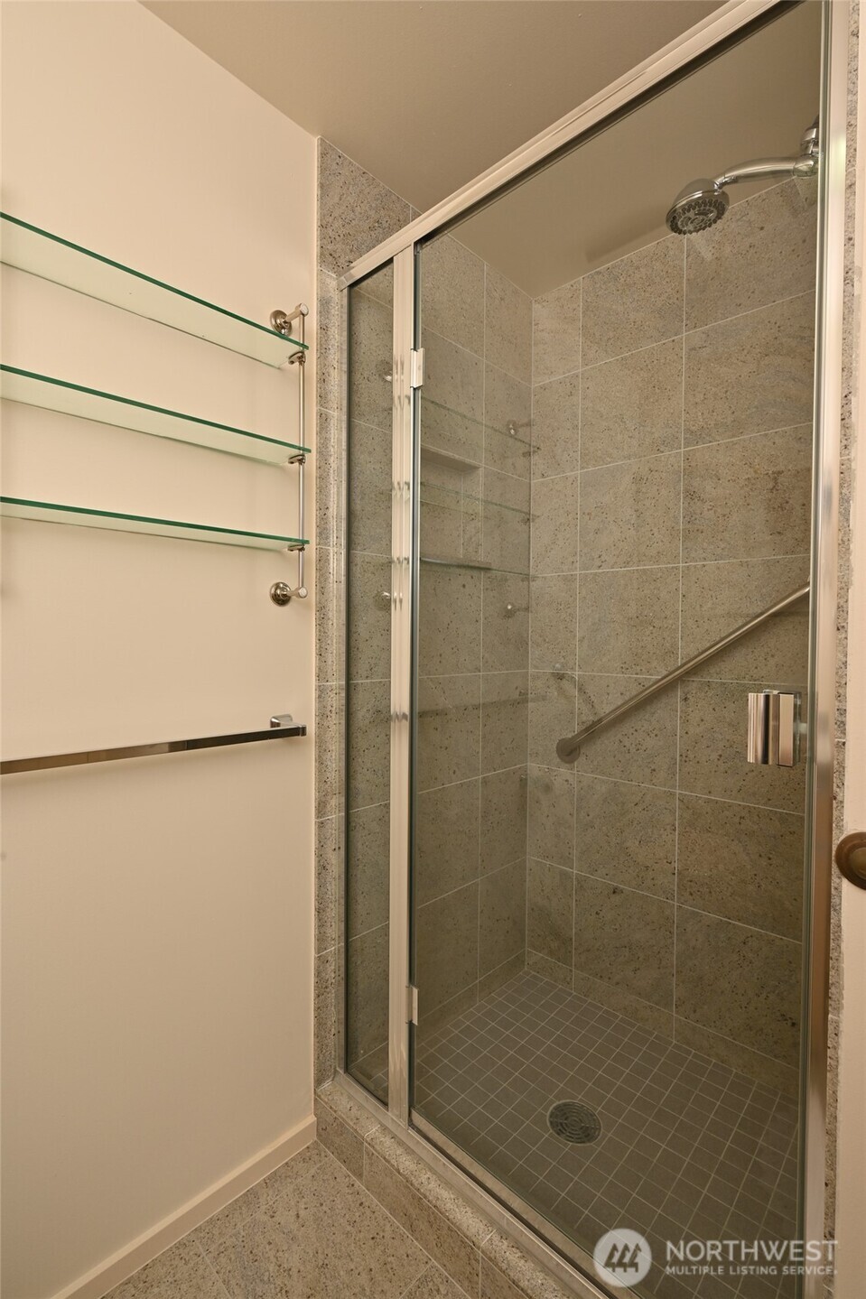 1301 Spring Street, Unit 6D Seattle, WA 98104 - Photo 22 of 29 a bathroom with a glass shower door